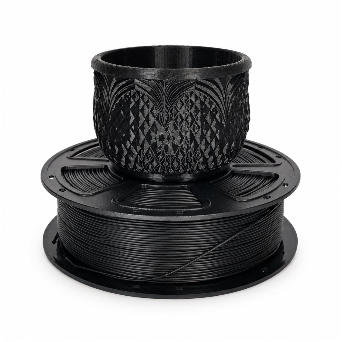 Black PLA filament spool with a detailed printed planter