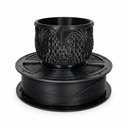 Black PLA filament spool with a detailed printed planter